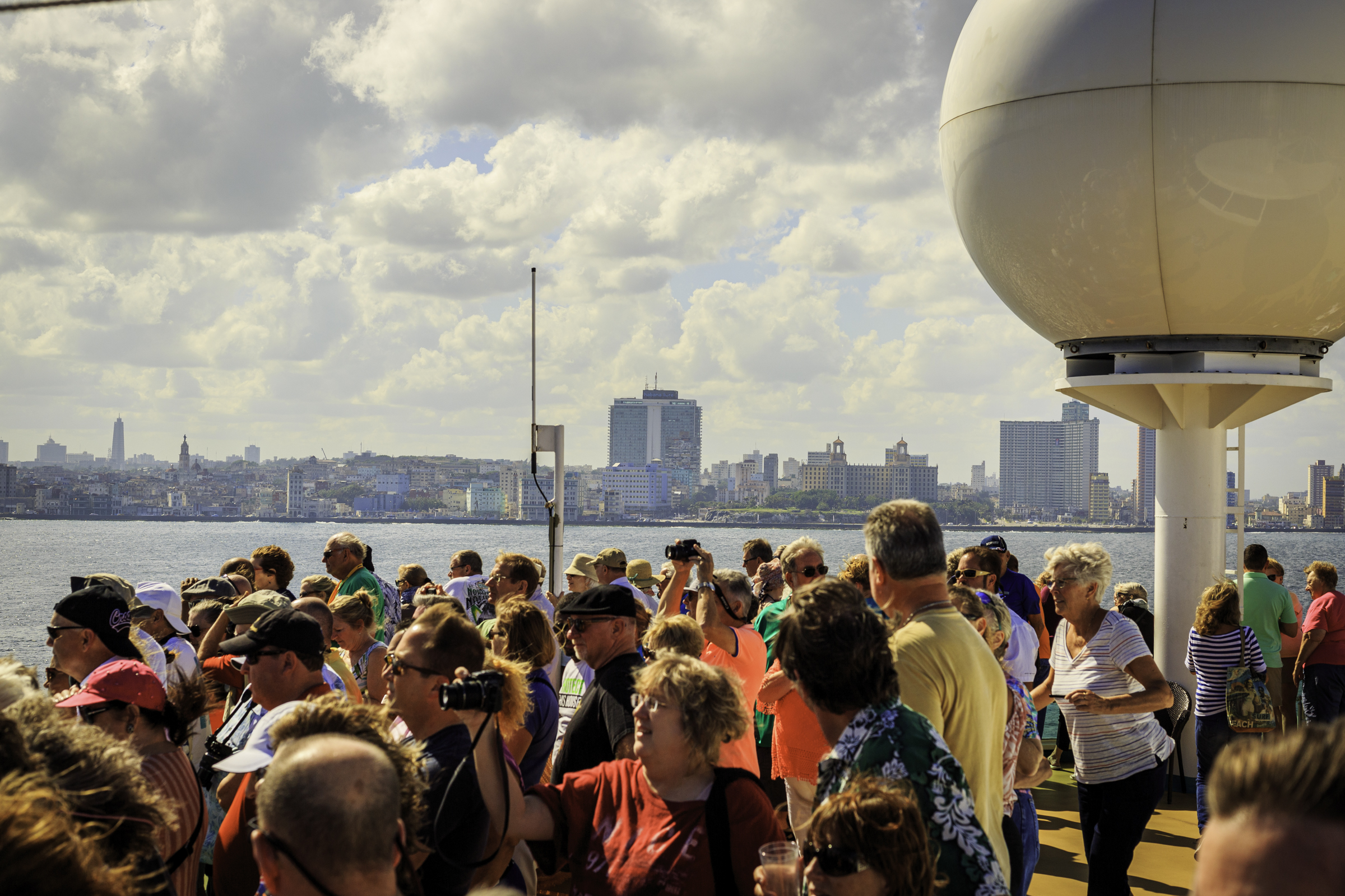 Cruise passengers gathering along the deck as Havana comes into view