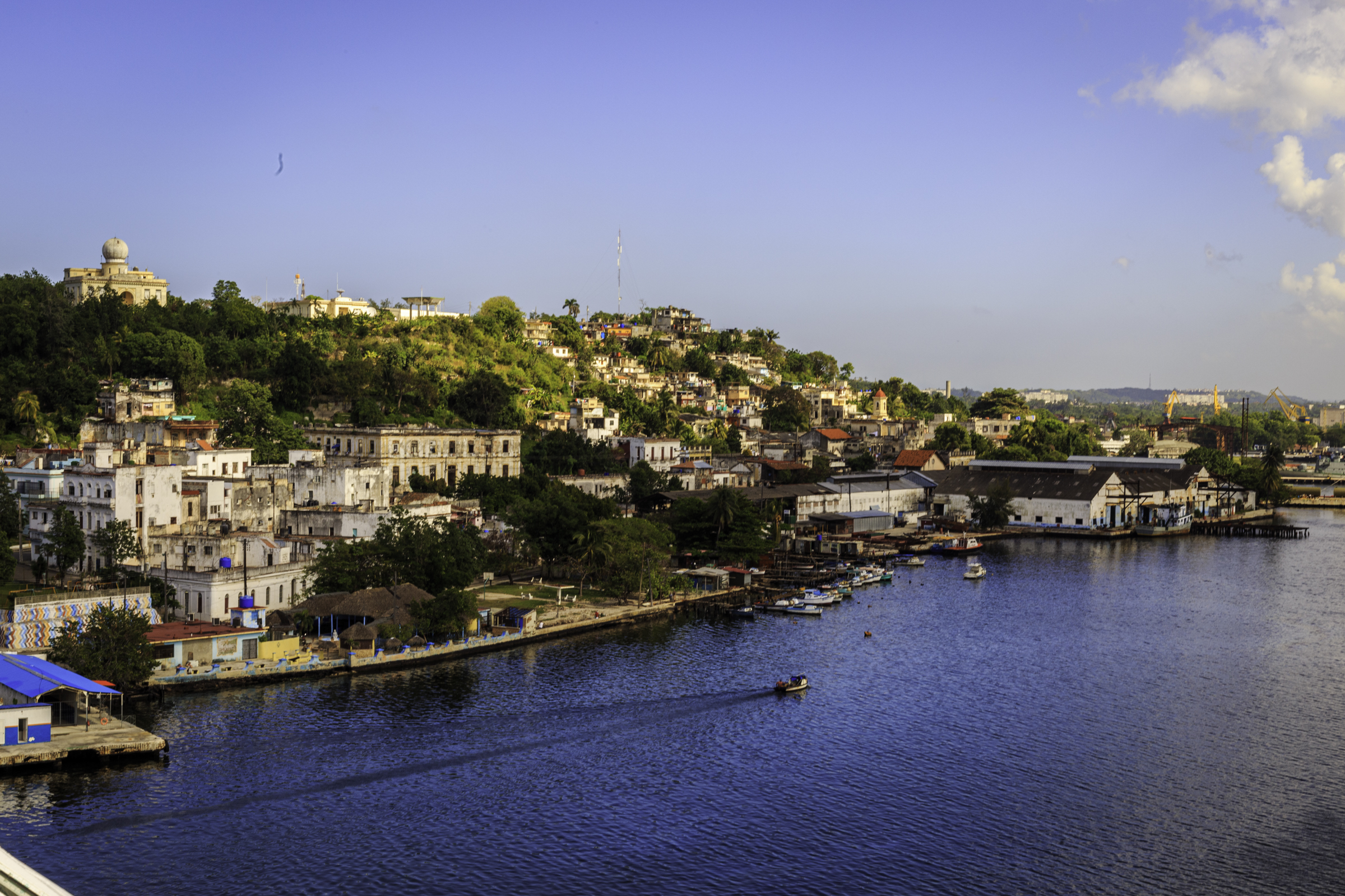 Homes, warehouses, boats, and a working shoreline inside Havana Harbor